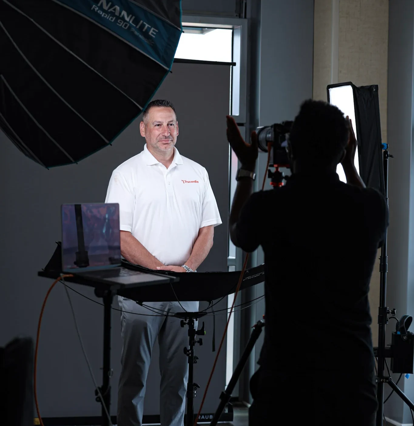 A man being photographed at a headshot session by Errol E Photography.