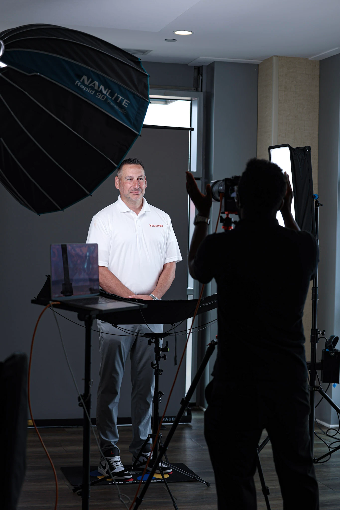 A man being photographed at a headshot session by Errol E Photography.