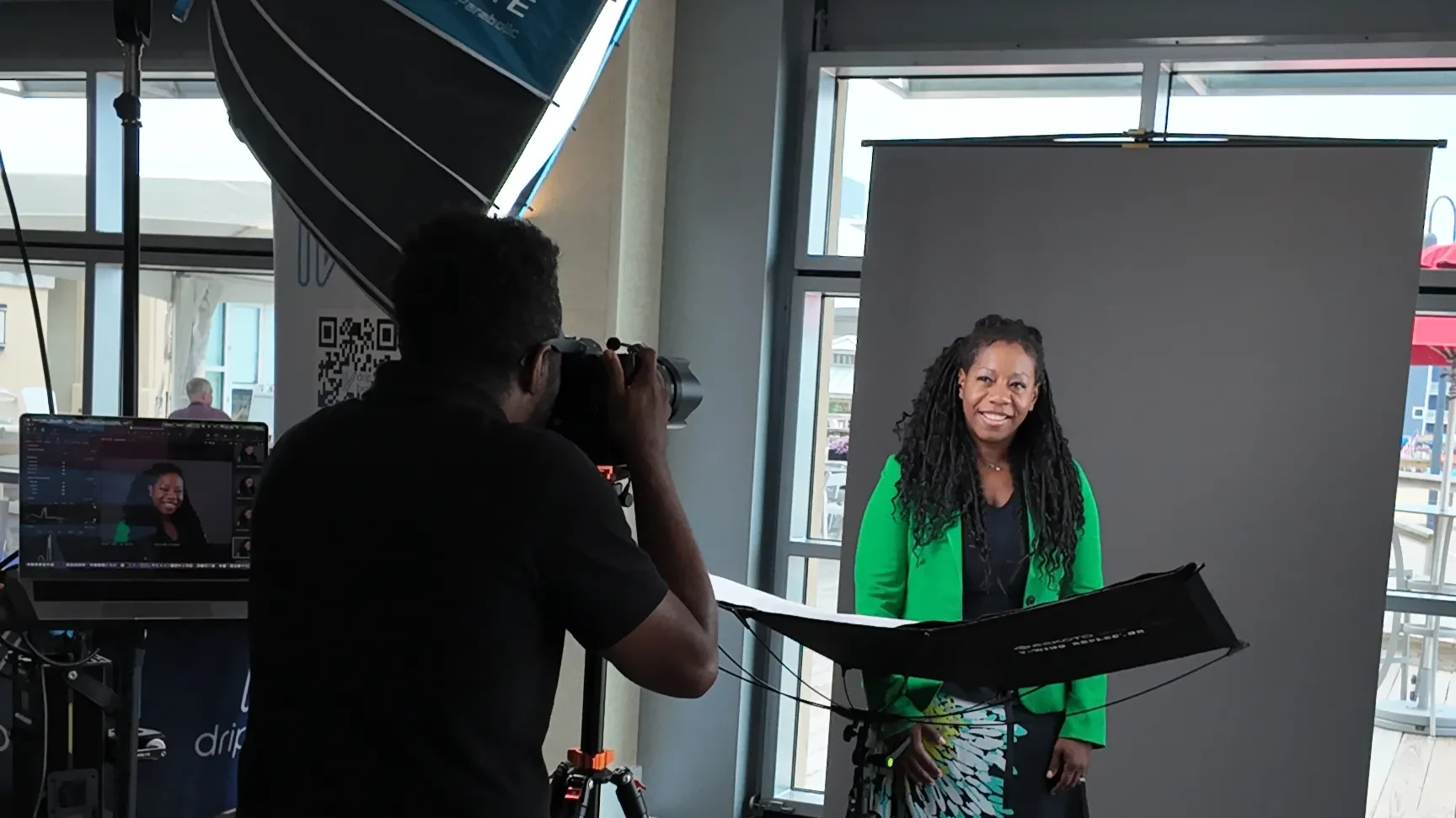 A headshot booth set up at a Delaware corporate event, with backdrop, lights, and a reflector