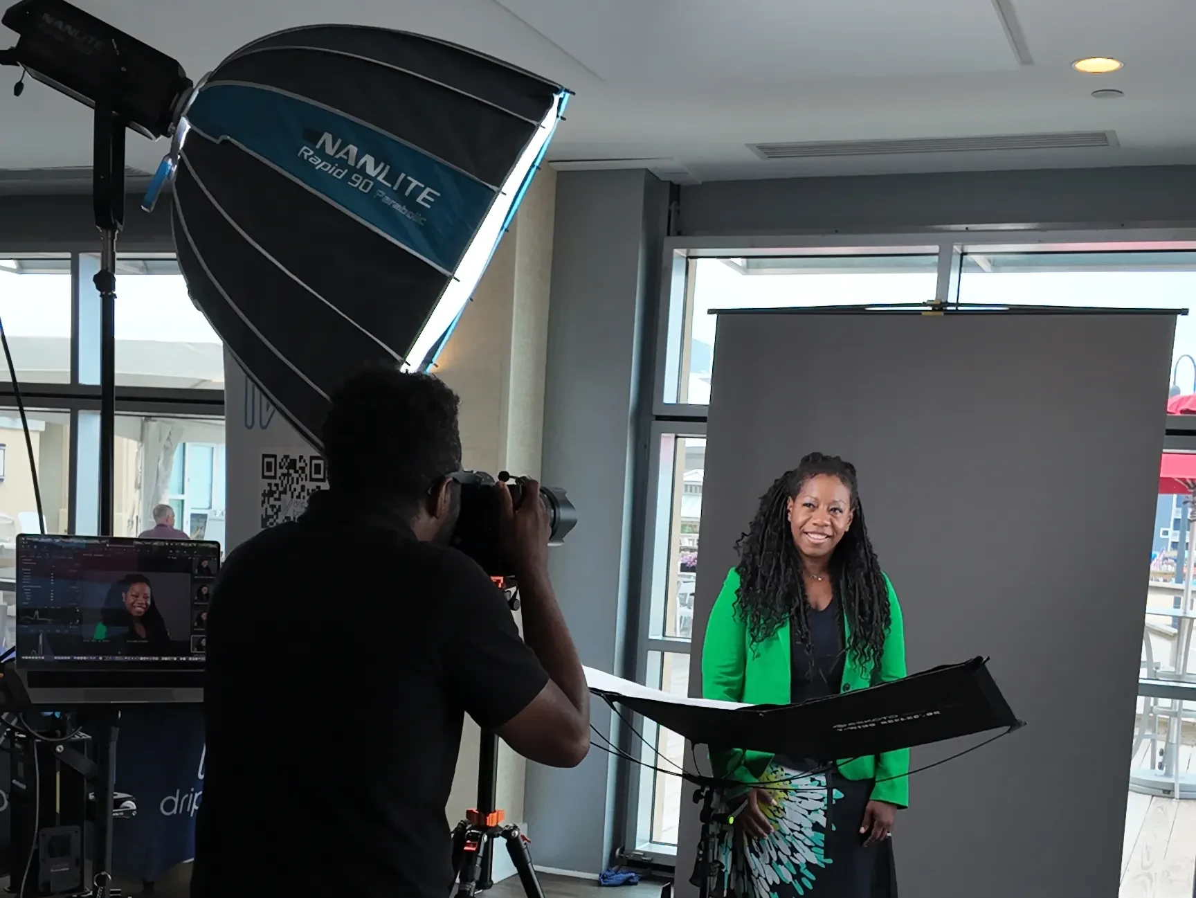 A headshot booth set up at a Delaware corporate event, with backdrop, lights, and a reflector